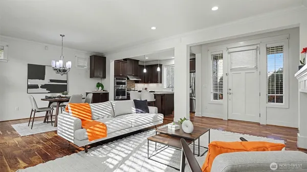 a living room with patio furniture and a flat screen tv