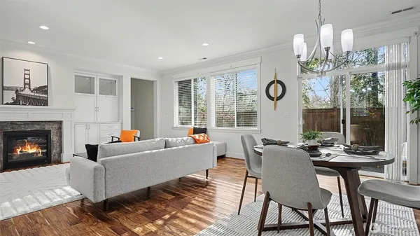 a living room with furniture a fireplace and a large window
