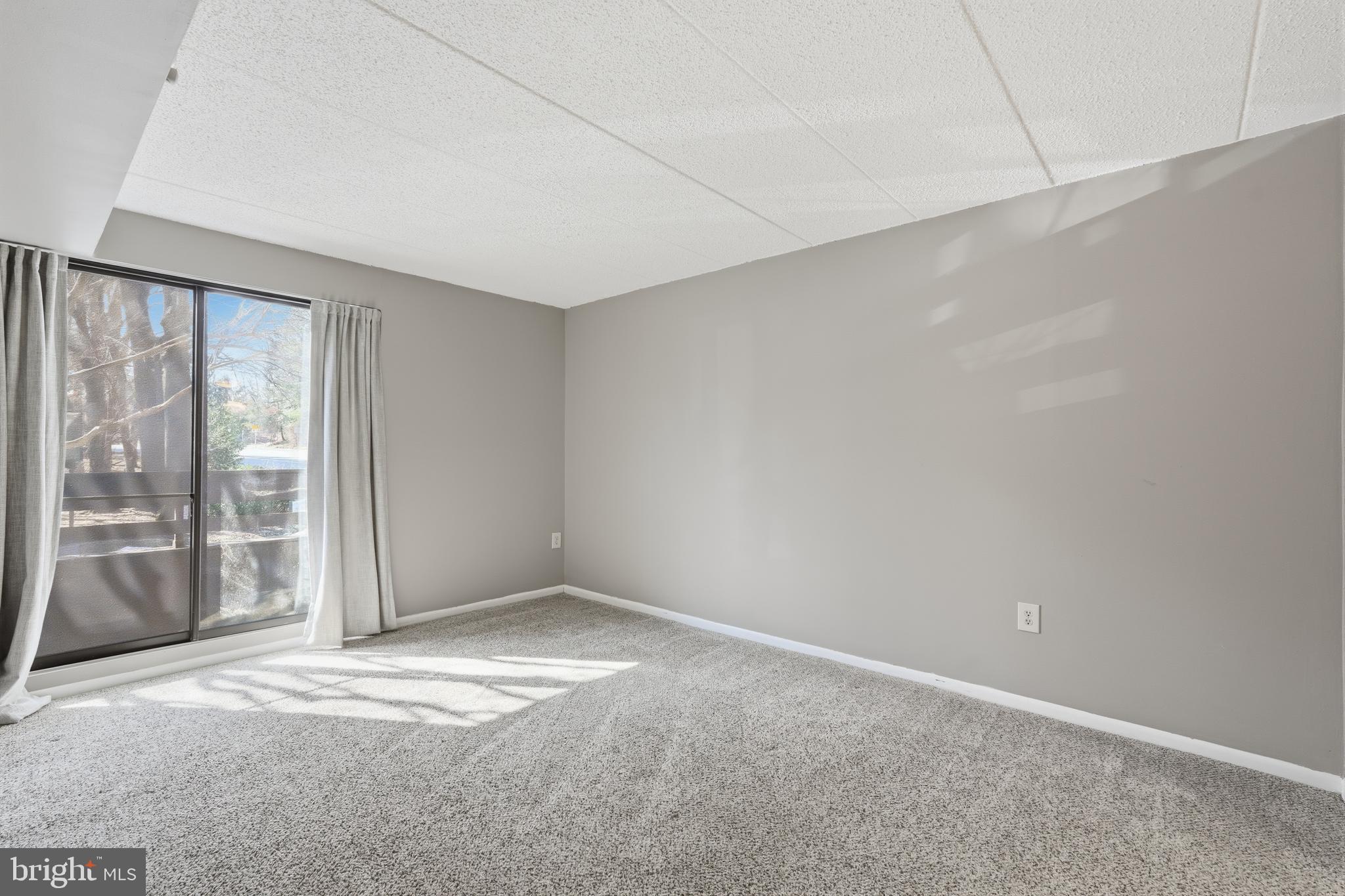 11566 Rolling Green Court, Unit 12/200A Reston, VA 20191 - Photo 17 of 25 an empty room with sliding door