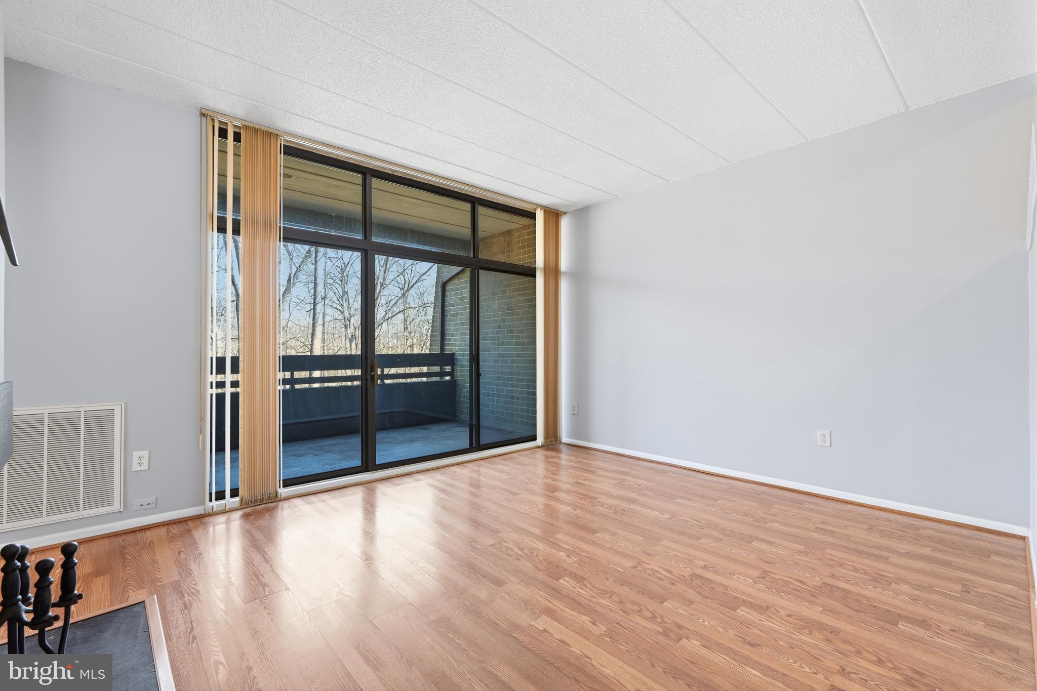 11566 Rolling Green Court, Unit 12/200A Reston, VA 20191 - Photo 4 of 25 wooden floor in an empty room with a window