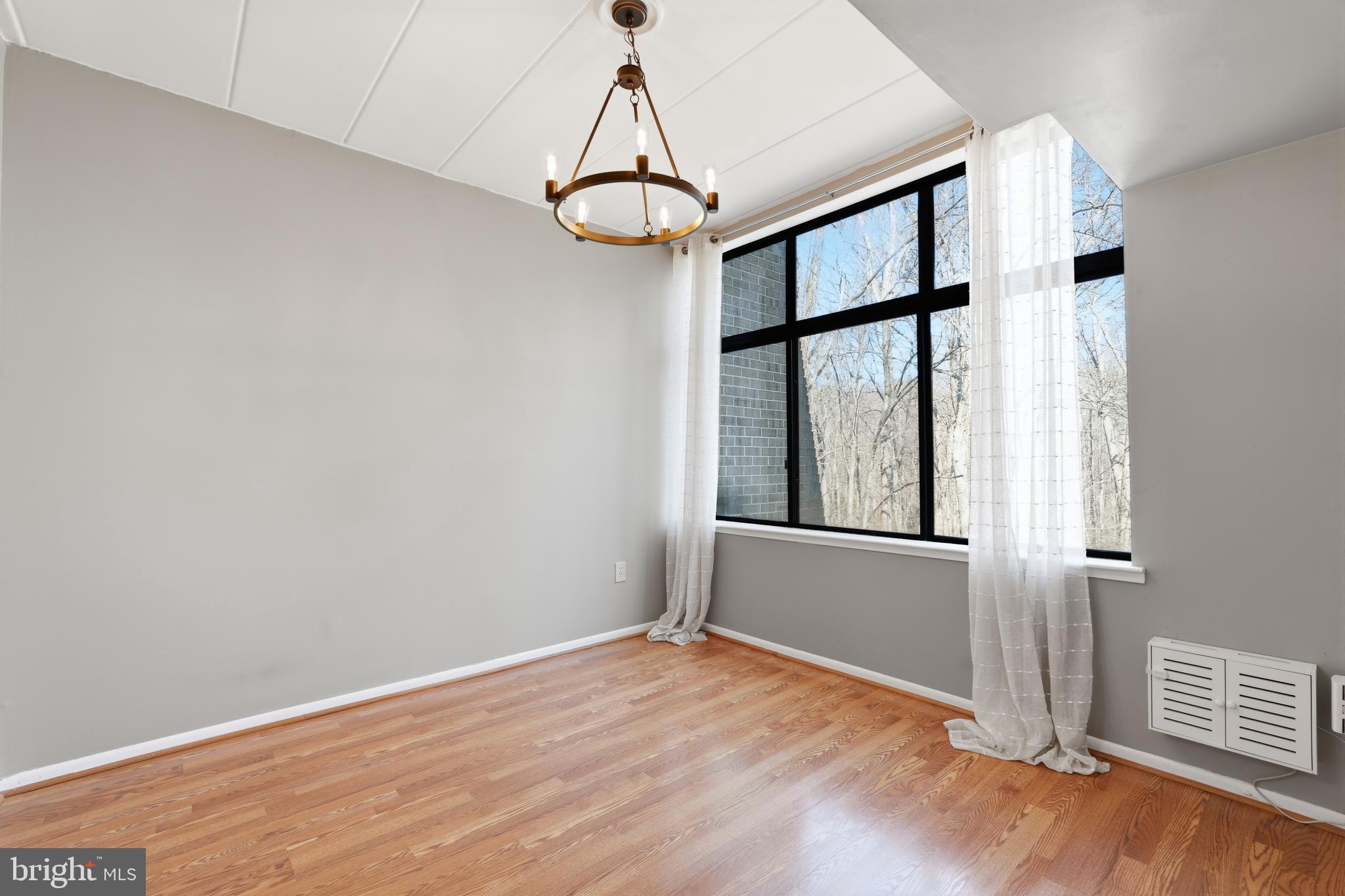 11566 Rolling Green Court, Unit 12/200A Reston, VA 20191 - Photo 7 of 25 a view of empty room with wooden floor and fan