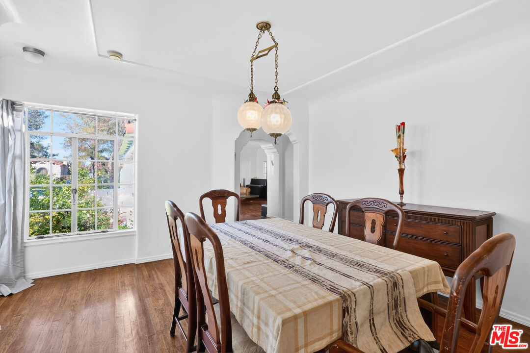 1544 South Point View Street Los Angeles, CA 90035 - Photo 19 of 67 a view of a dining room with furniture window and wooden floor