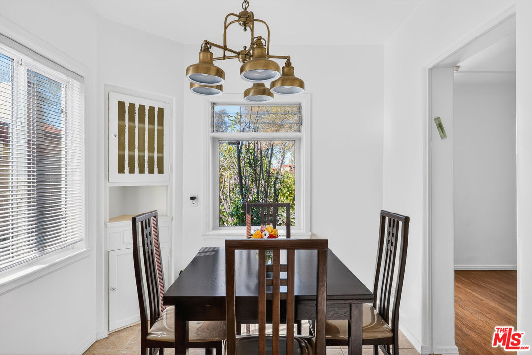 1544 South Point View Street Los Angeles, CA 90035 - Photo 22 of 67 a view of a dining room with furniture window and outside view