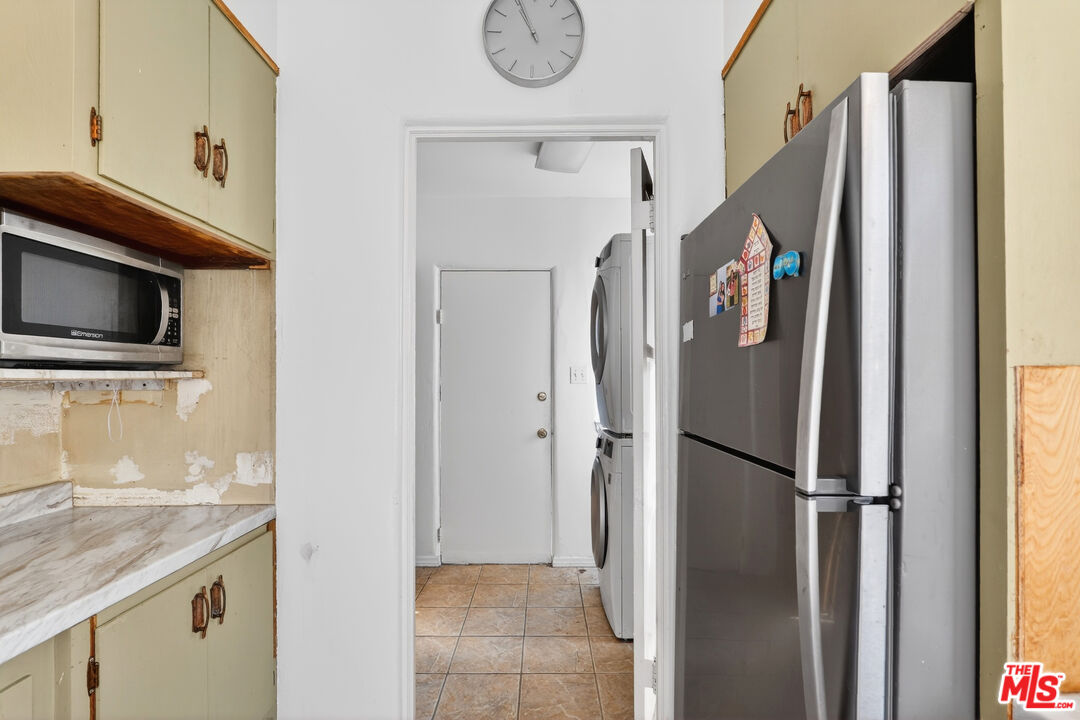 1544 South Point View Street Los Angeles, CA 90035 - Photo 28 of 67 a view of kitchen with a refrigerator cabinet and a flat screen tv