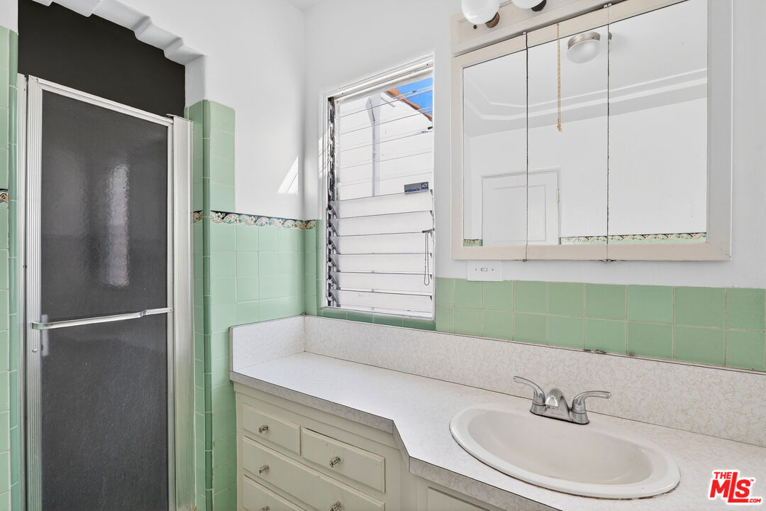 1544 South Point View Street Los Angeles, CA 90035 - Photo 33 of 67 a bathroom with a sink and a mirror