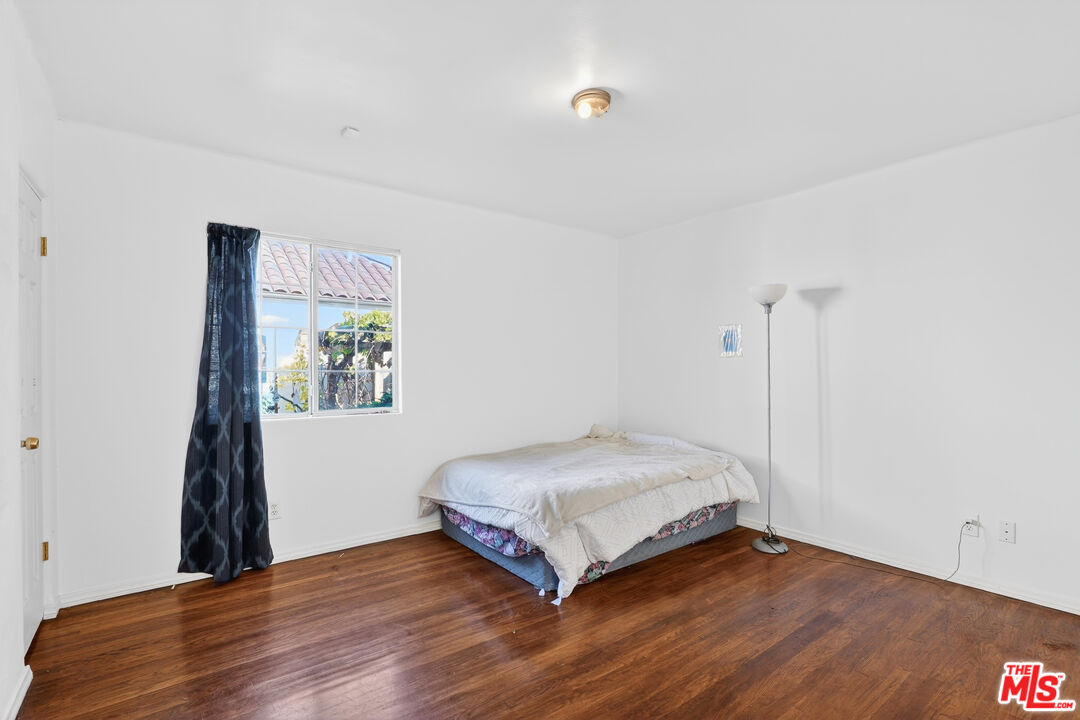 1544 South Point View Street Los Angeles, CA 90035 - Photo 36 of 67 a view of bedroom with wooden floor and window