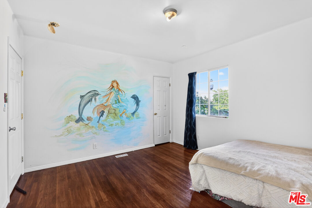 1544 South Point View Street Los Angeles, CA 90035 - Photo 37 of 67 a bedroom with a bed and painting on the wall