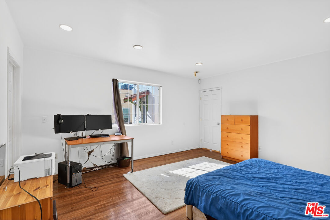 1544 South Point View Street Los Angeles, CA 90035 - Photo 39 of 67 a bedroom that has a bed and a desk in it