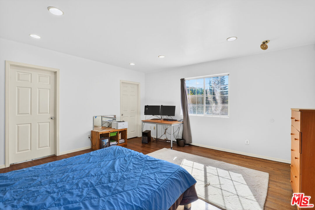 1544 South Point View Street Los Angeles, CA 90035 - Photo 40 of 67 a bedroom with a bed and wooden floor