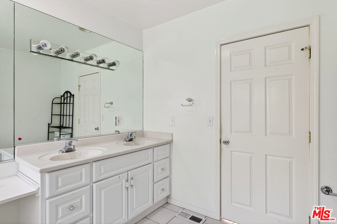 1544 South Point View Street Los Angeles, CA 90035 - Photo 43 of 67 a bathroom with 2 sink and a mirror