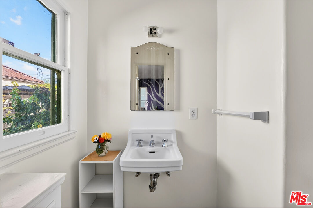 1544 South Point View Street Los Angeles, CA 90035 - Photo 45 of 67 a bathroom with a sink and a mirror