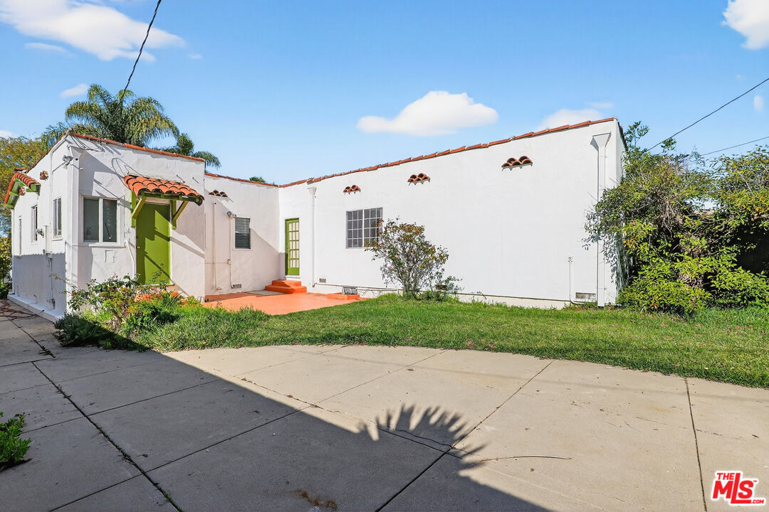 1544 South Point View Street Los Angeles, CA 90035 - Photo 48 of 67 a view of a white house with a yard and potted plants