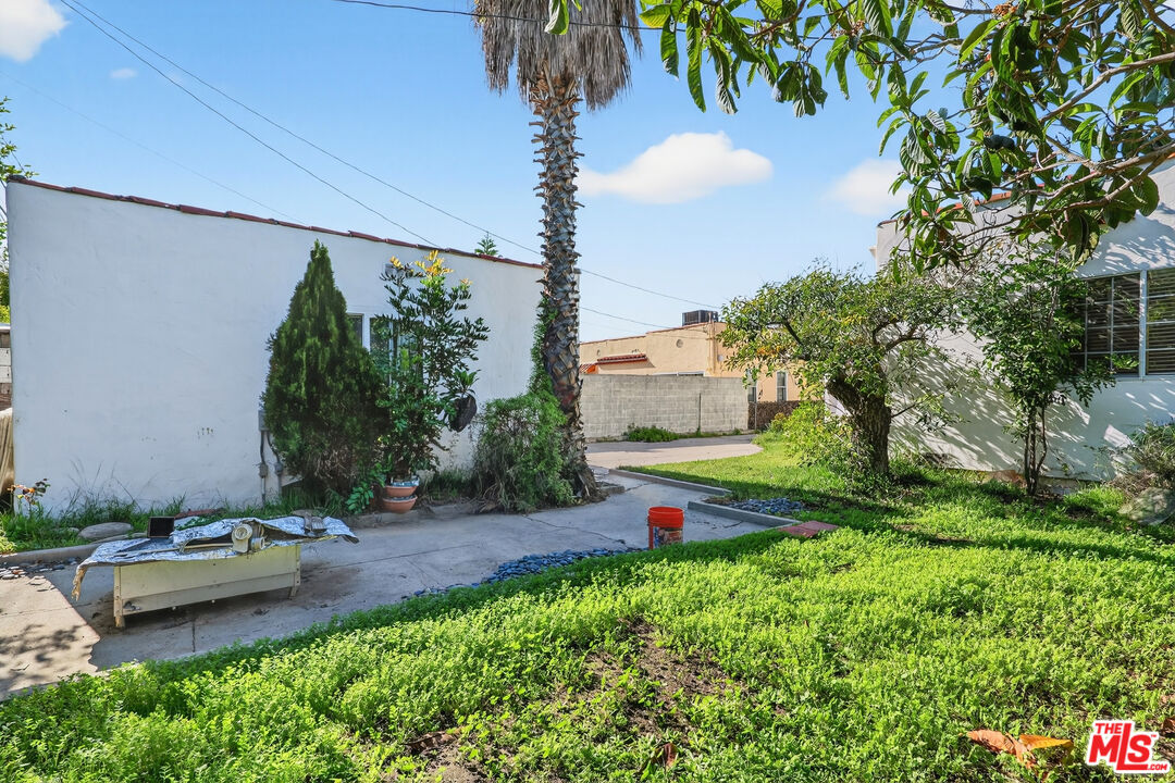1544 South Point View Street Los Angeles, CA 90035 - Photo 52 of 67 a view of a backyard with plants and a fountain