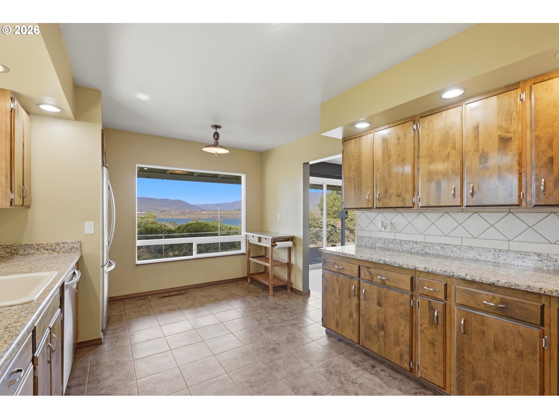 1829 East 8th Street The Dalles, OR 97058 - Photo 11 of 48 a view of a kitchen with a sink and a large window