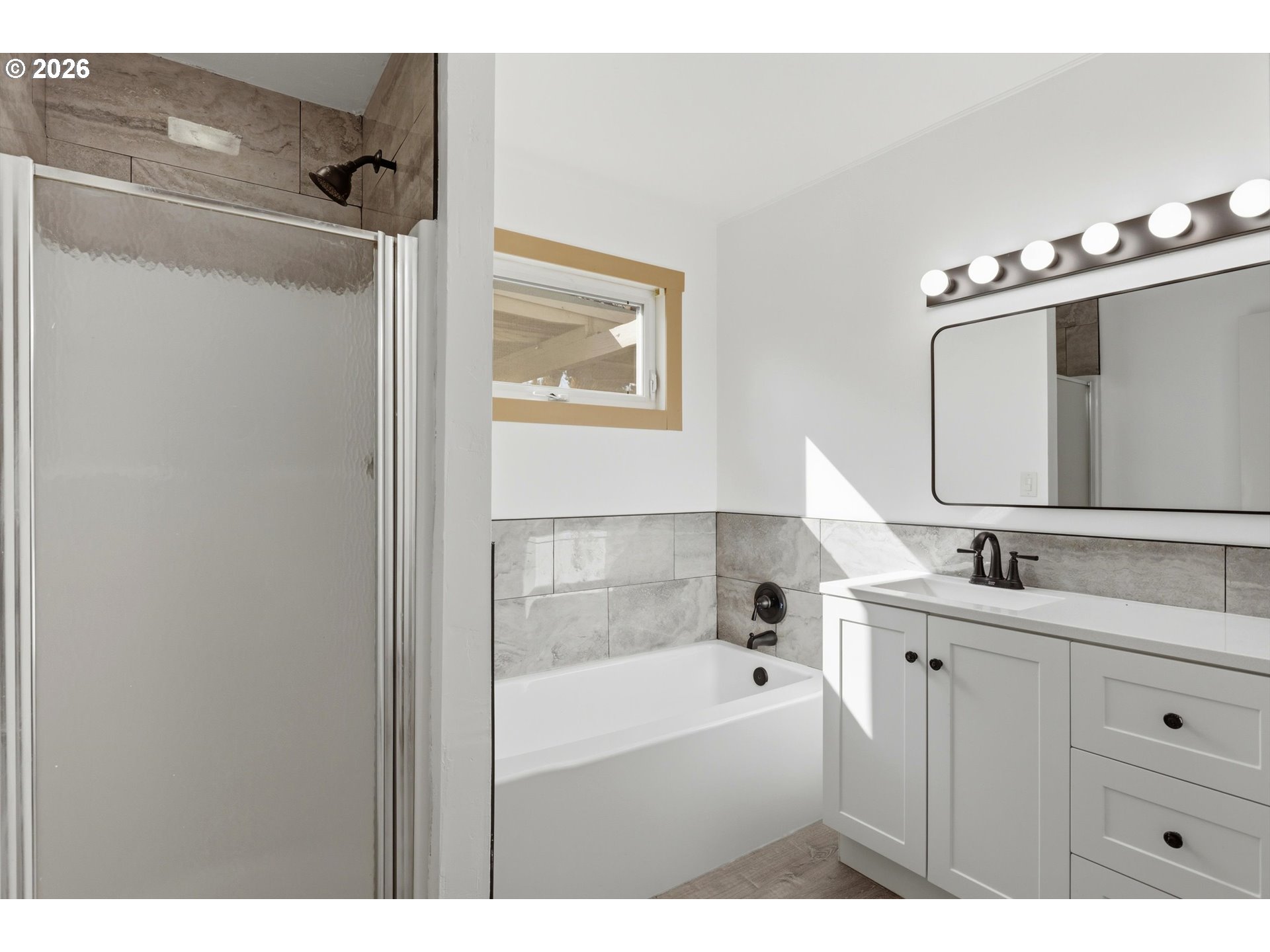1829 East 8th Street The Dalles, OR 97058 - Photo 18 of 48 a bathroom with a tub sink double vanity and mirror