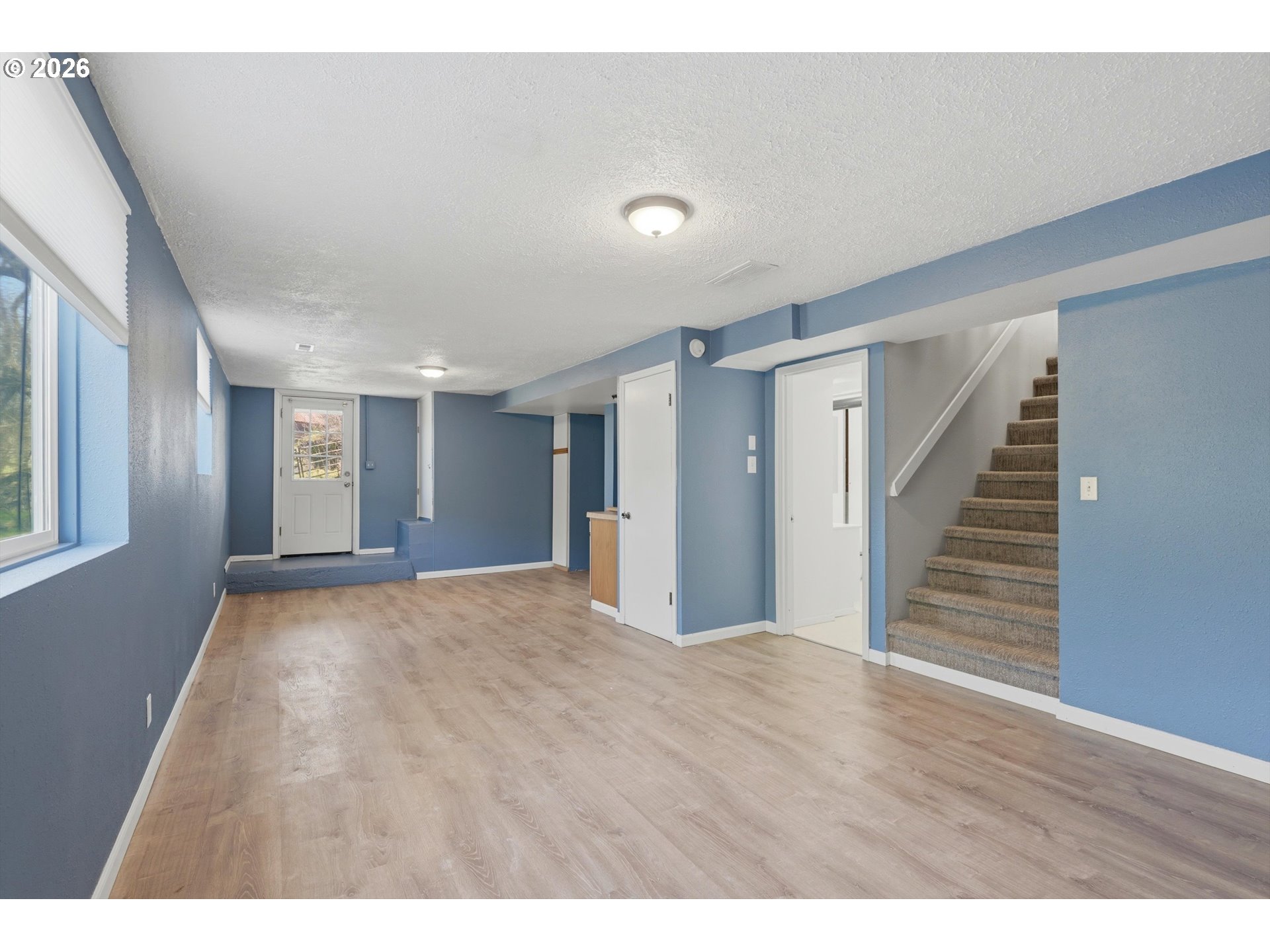 1829 East 8th Street The Dalles, OR 97058 - Photo 22 of 48 a view of an empty room with wooden floor and stairs