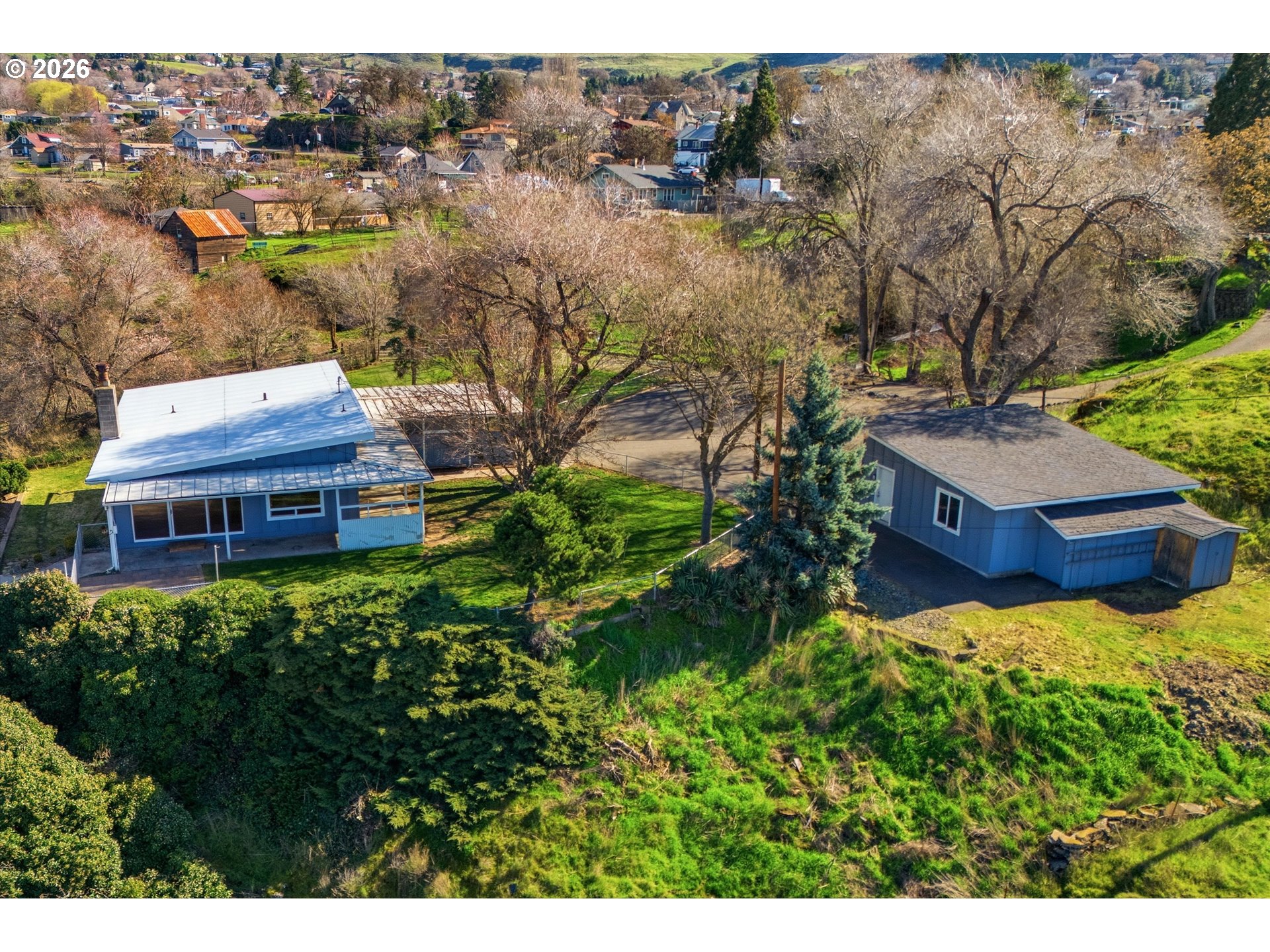 1829 East 8th Street The Dalles, OR 97058 - Photo 47 of 48 a view of a house with a big yard plants and large trees
