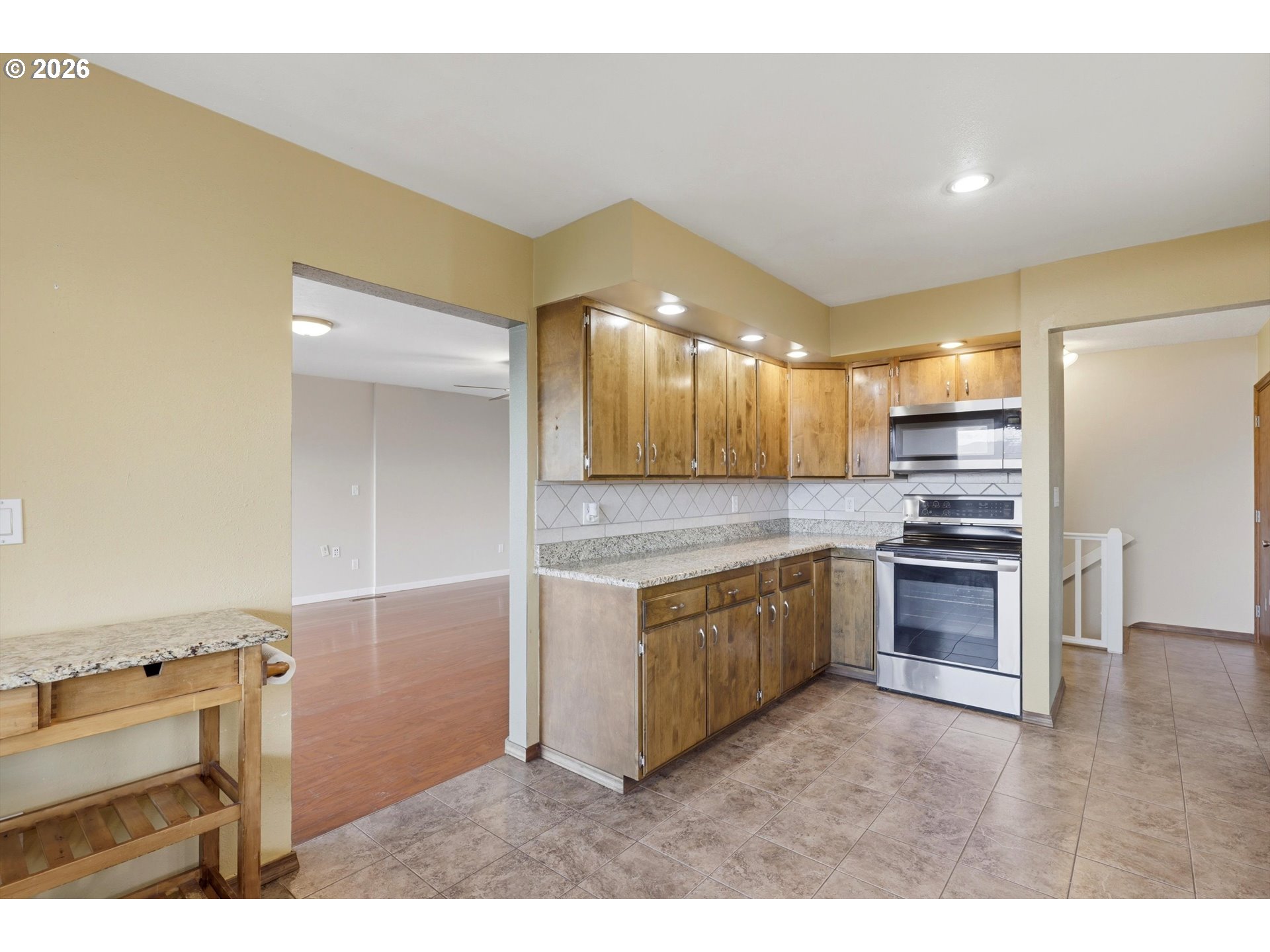 1829 East 8th Street The Dalles, OR 97058 - Photo 9 of 48 a kitchen with kitchen island granite countertop a stove and a sink
