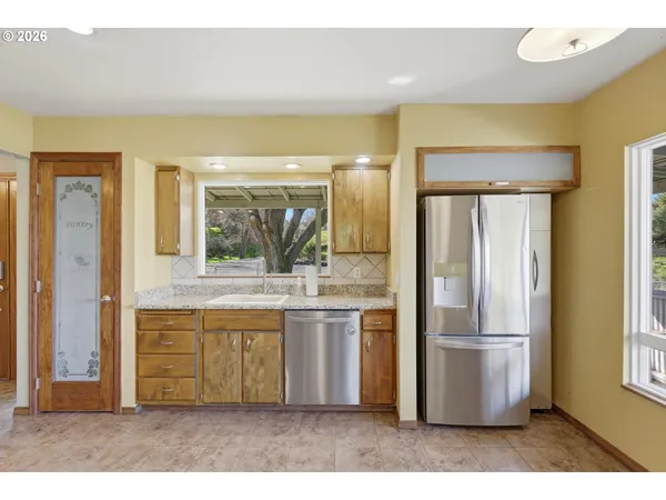 a view of a kitchen with a sink and a large window