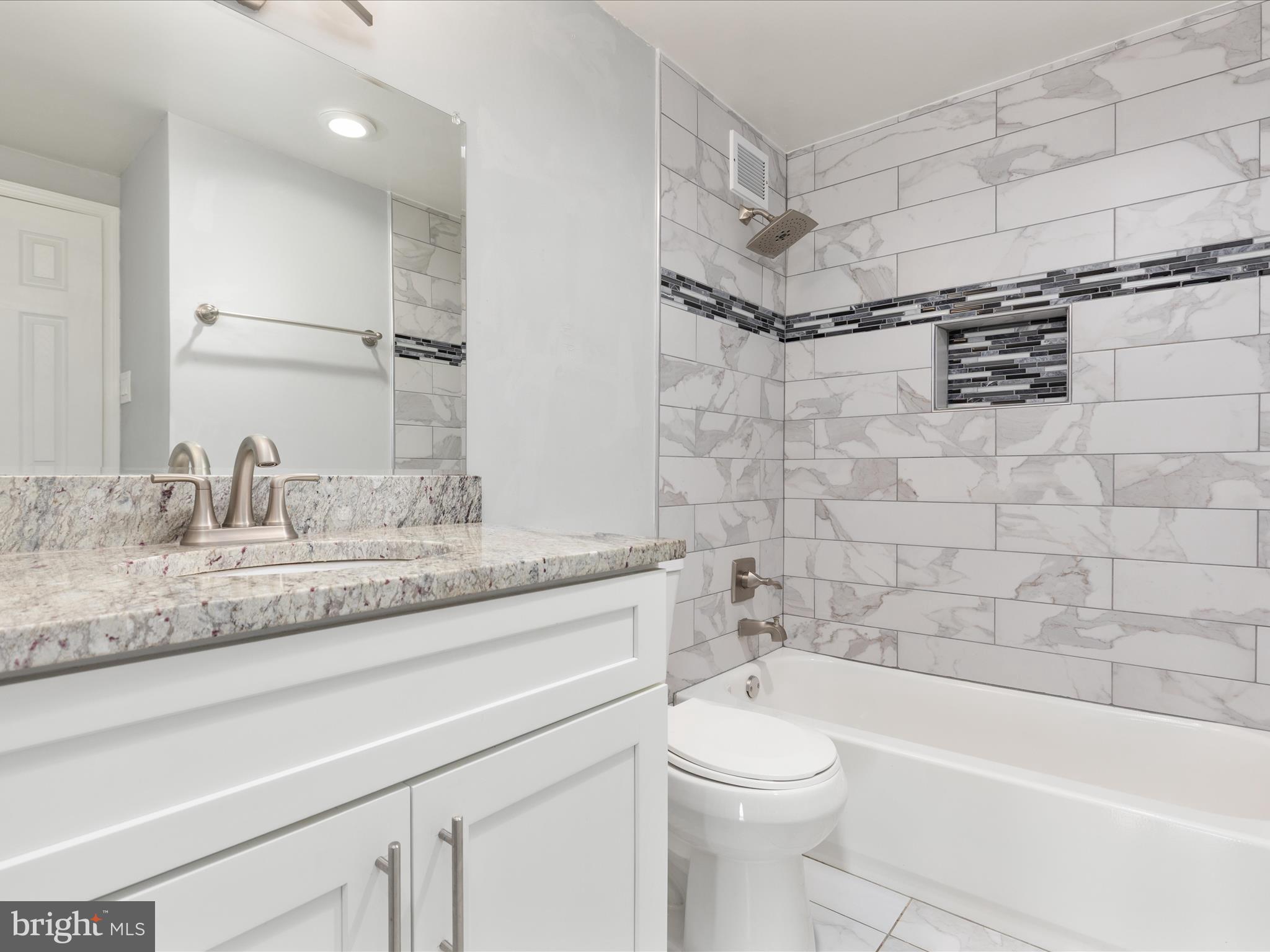 4141 North Henderson Road, Unit 809 Arlington, VA 22203 - Photo 11 of 21 a bathroom with a granite countertop sink a toilet and bathtub