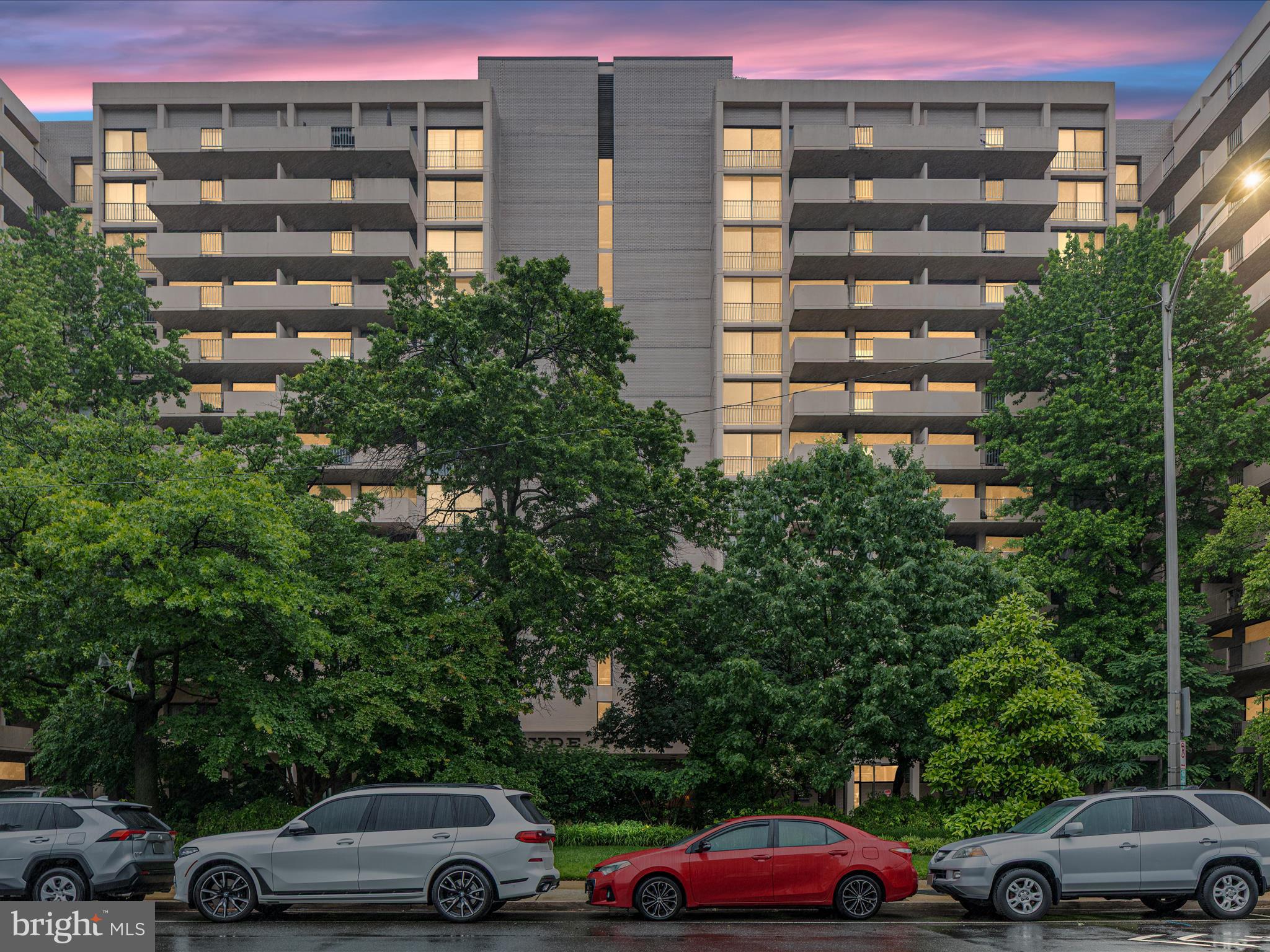 4141 North Henderson Road, Unit 809 Arlington, VA 22203 - Photo 2 of 21 a front view of a residential apartment building with a yard