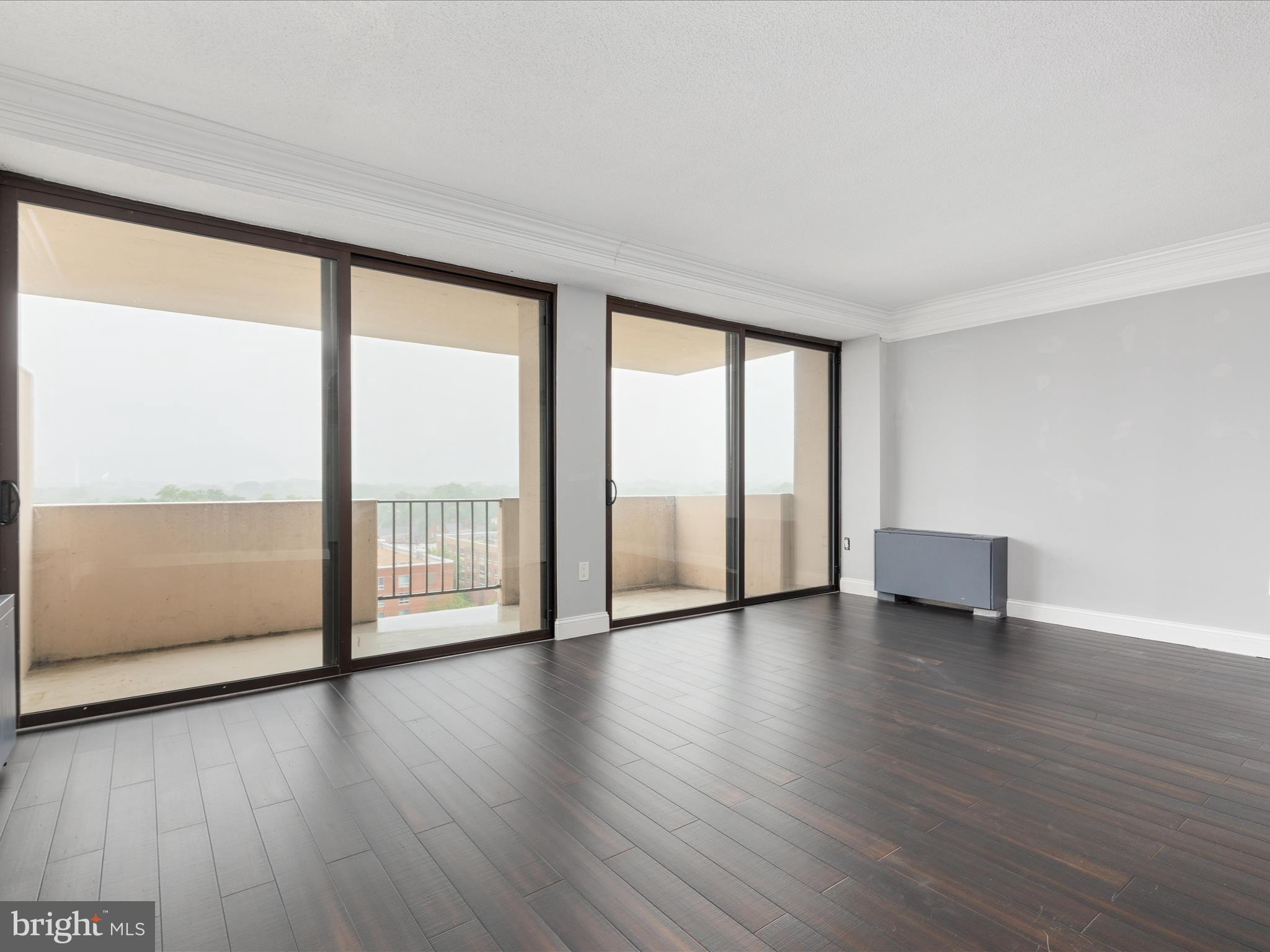 4141 North Henderson Road, Unit 809 Arlington, VA 22203 - Photo 3 of 21 a view of an empty room with wooden floor and a window