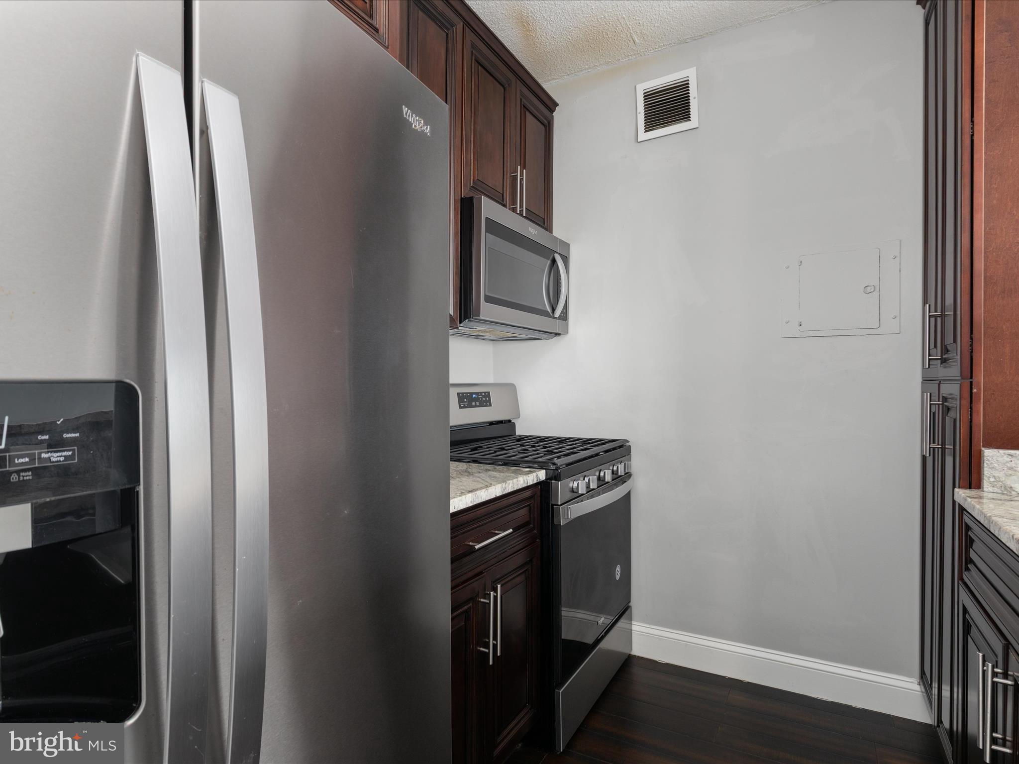 4141 North Henderson Road, Unit 809 Arlington, VA 22203 - Photo 8 of 21 a kitchen with stainless steel appliances granite countertop a refrigerator and a stove
