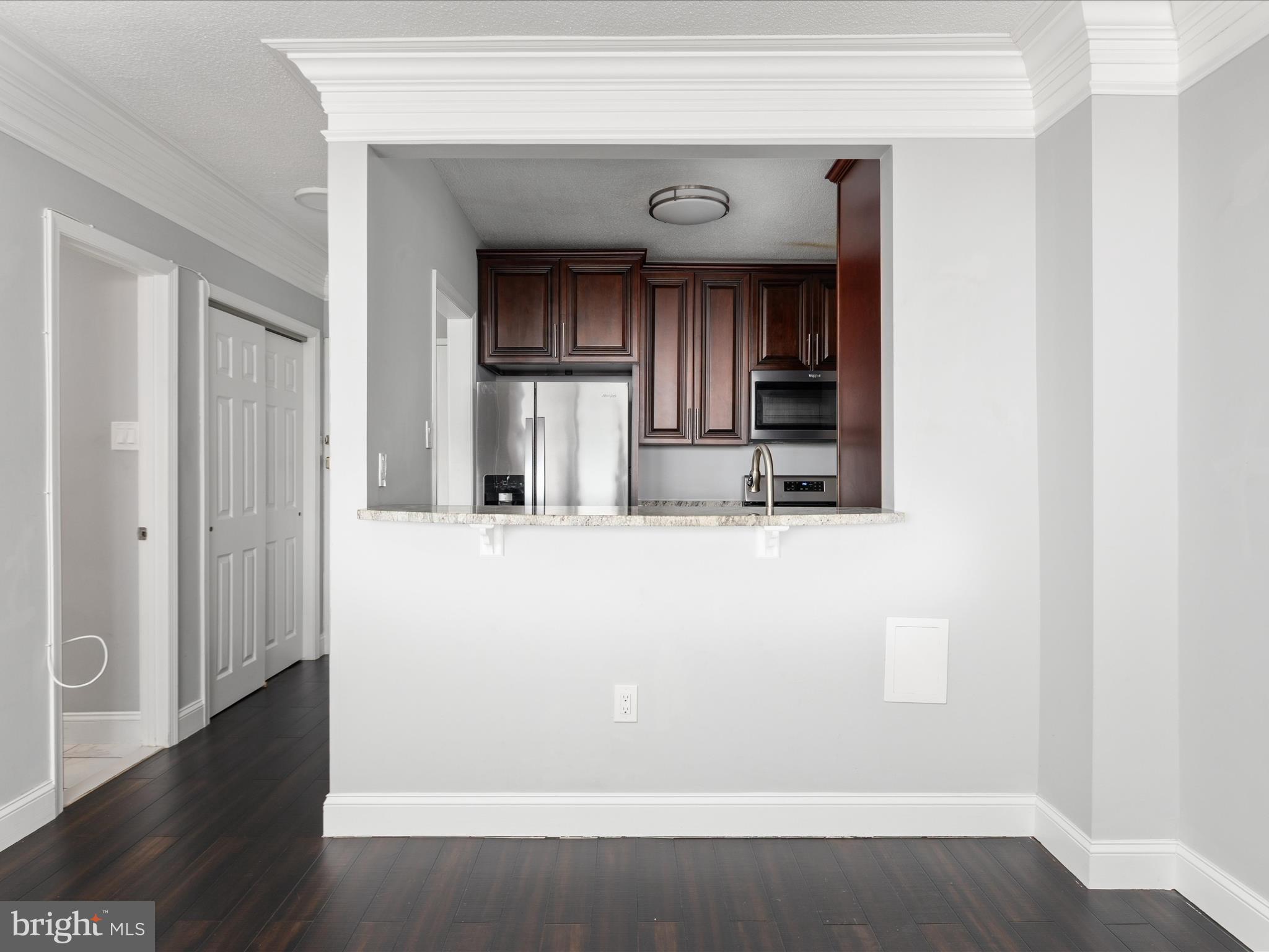 4141 North Henderson Road, Unit 809 Arlington, VA 22203 - Photo 9 of 21 a view of kitchen with wooden floor and electronic appliances