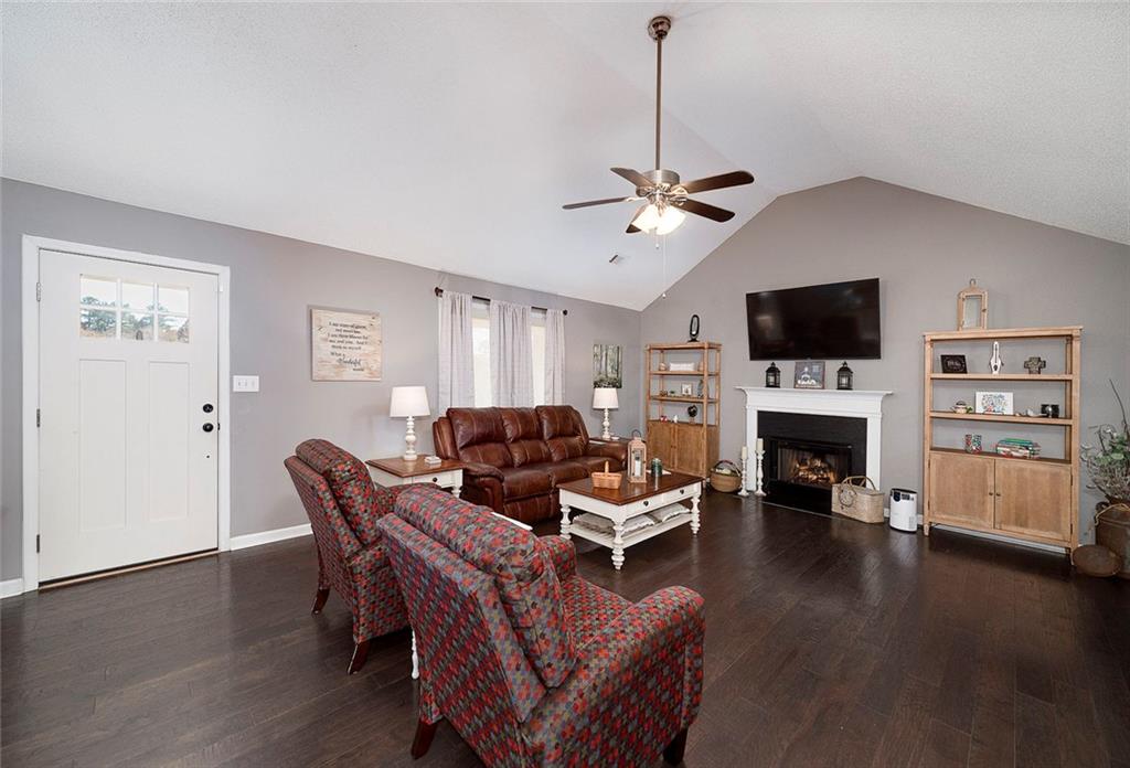 121 Harper Road McDonough, GA 30252 - Photo 12 of 38 a living room with furniture a fireplace and a flat screen tv