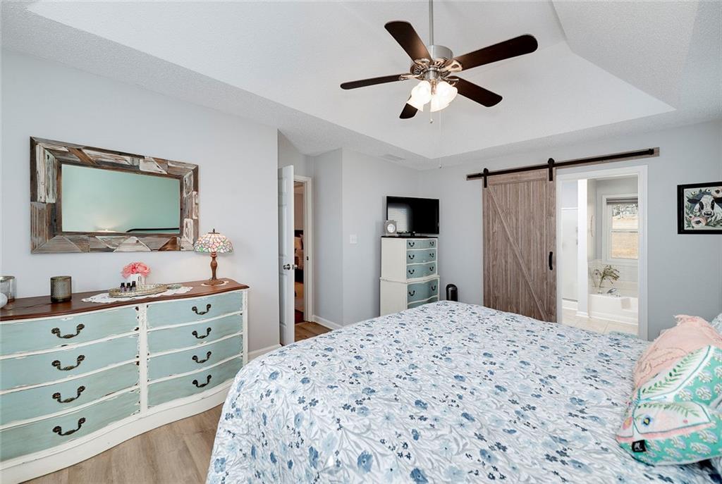 121 Harper Road McDonough, GA 30252 - Photo 26 of 38 a bedroom with a bed and a flat screen tv