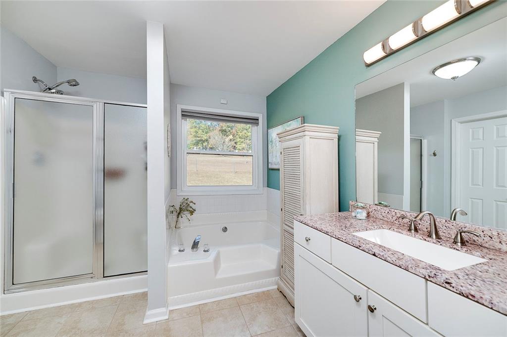 121 Harper Road McDonough, GA 30252 - Photo 27 of 38 a bathroom with a granite countertop sink and a mirror