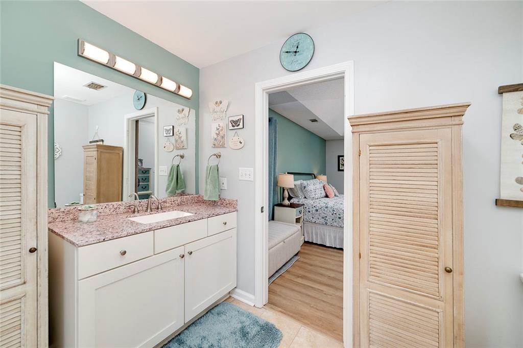 121 Harper Road McDonough, GA 30252 - Photo 28 of 38 a en suite bathroom with a sink and a mirror
