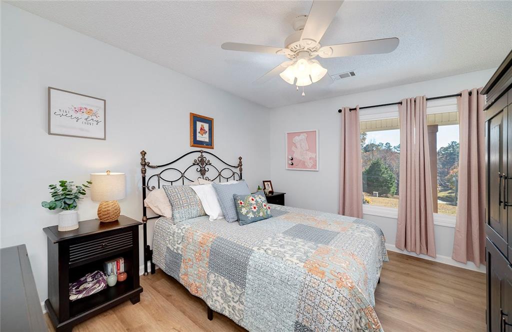 121 Harper Road McDonough, GA 30252 - Photo 30 of 38 a bedroom with a bed and a chandelier