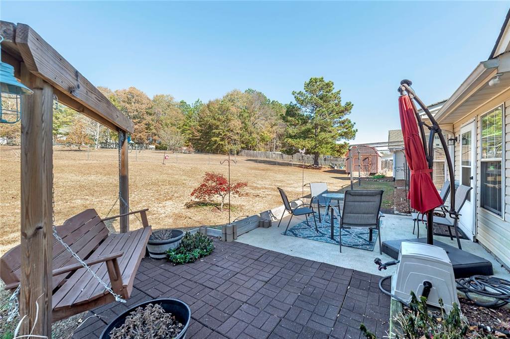 121 Harper Road McDonough, GA 30252 - Photo 9 of 38 a view of a patio with a table chairs and a potted plant