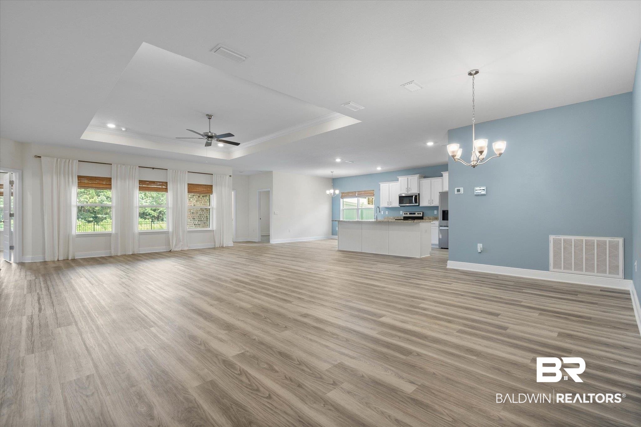 11229 Genuine Risk Circle Daphne, AL 36526 - Photo 4 of 46 Living room with a raised ceiling, LVP finished floors, recessed lighting, open concept.