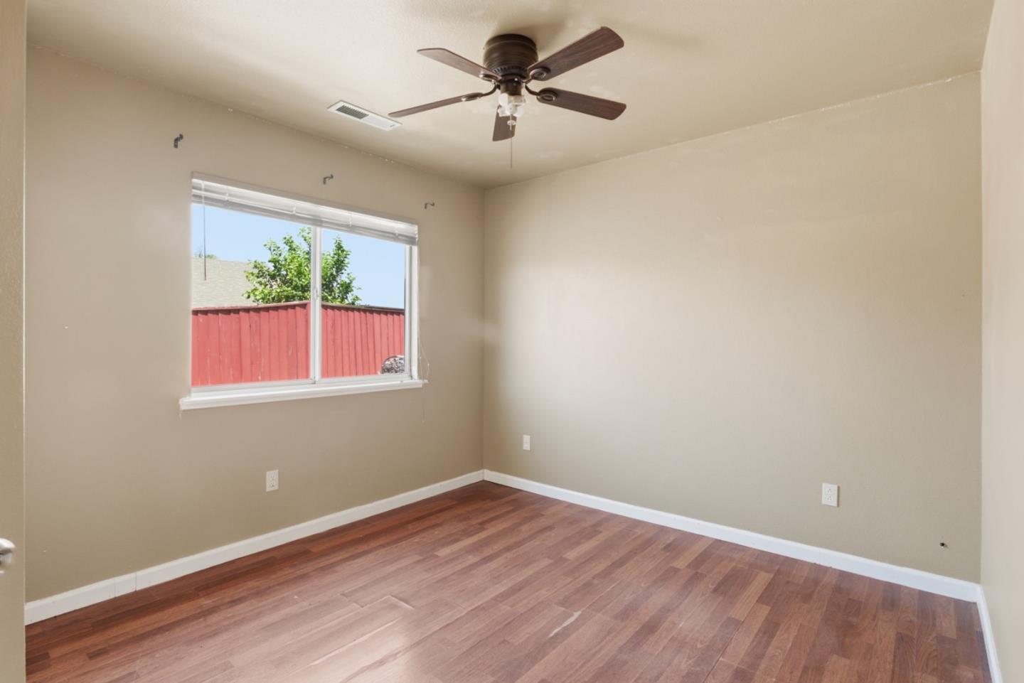 449 Sage Court Soledad, CA 93960 - Photo 9 of 17 wooden floor in an empty room with a window