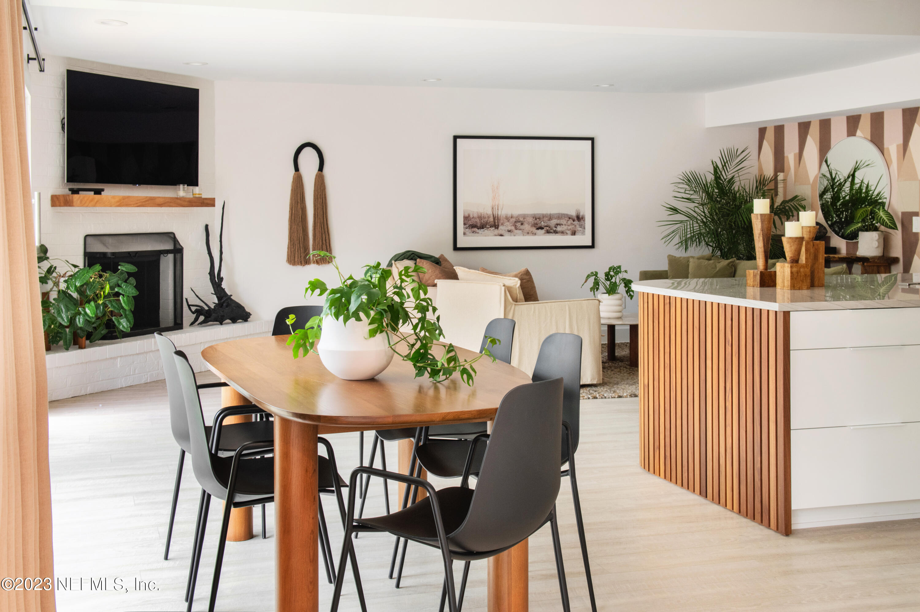 962 Ocean Boulevard Atlantic Beach, FL 32233 - Photo 18 of 63 a view of a dining room with furniture and a flat screen tv