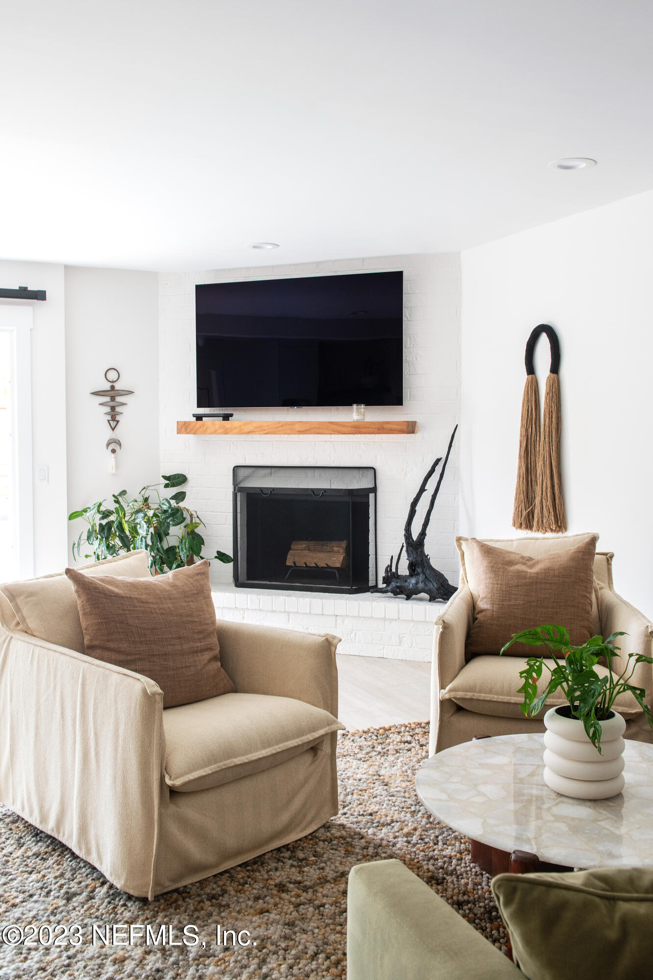 962 Ocean Boulevard Atlantic Beach, FL 32233 - Photo 26 of 63 a living room with furniture a flat screen tv and a fireplace