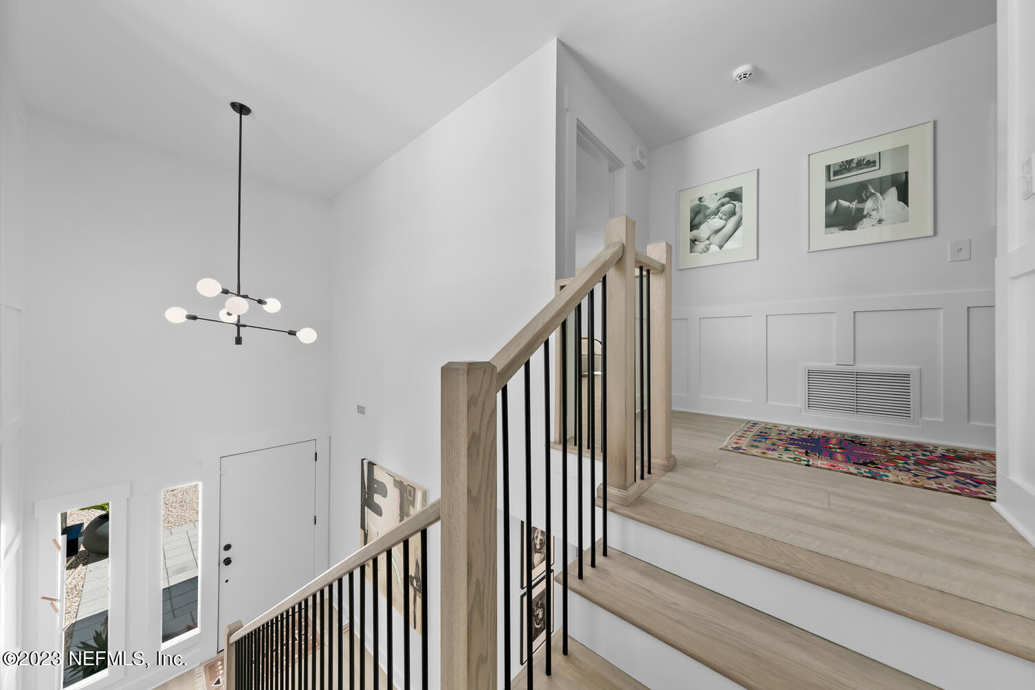 962 Ocean Boulevard Atlantic Beach, FL 32233 - Photo 33 of 63 a view of a hallway with wooden floor and stairs