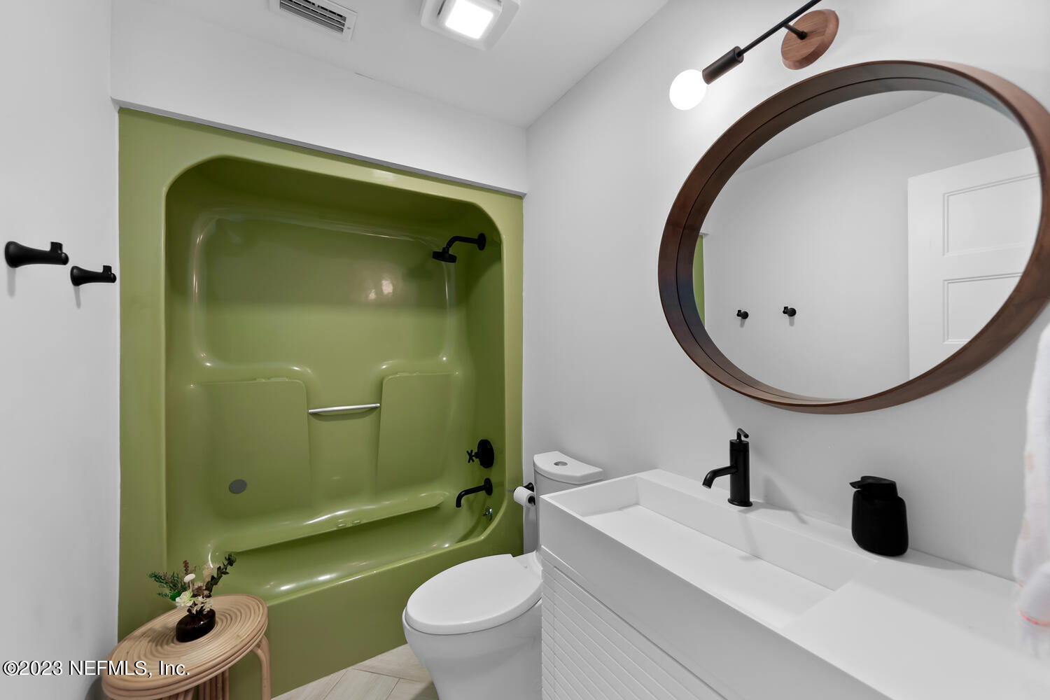 962 Ocean Boulevard Atlantic Beach, FL 32233 - Photo 41 of 63 a bathroom with a sink a toilet and a mirror