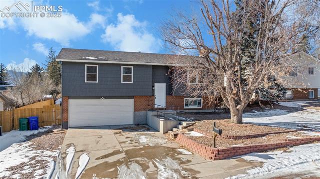 6319 Chippewa Road Colorado Springs, CO 80915 - Photo 2 of 36 Split foyer home featuring a garage