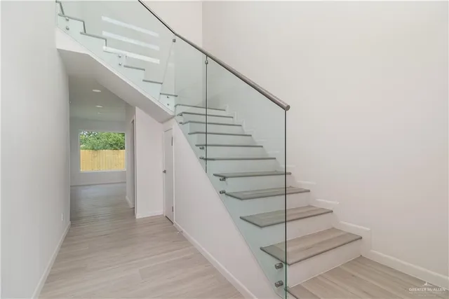 a view of entryway and hall with wooden floor