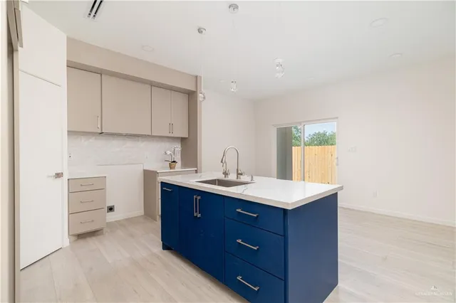 a kitchen with a sink and cabinets