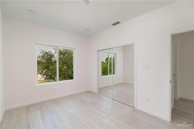 an empty room with windows and garden