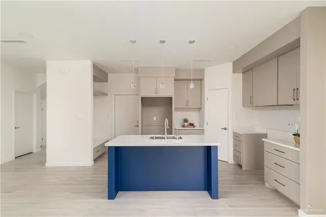 a kitchen with cabinets a sink and appliances