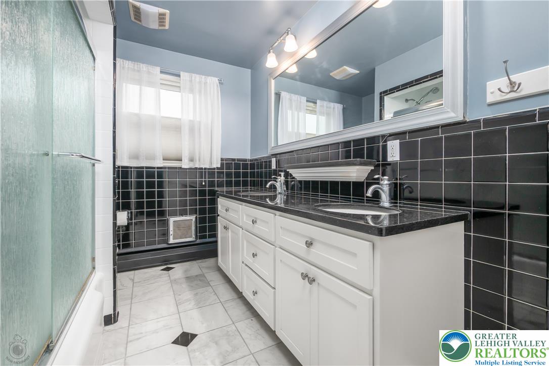 3517 Fish Hatchery Road Allentown, PA 18103 - Photo 21 of 41 a bathroom with a granite countertop sink a toilet and a shower