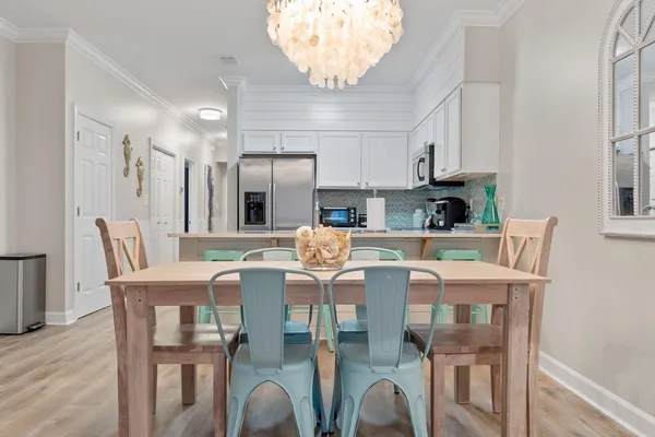 a view of kitchen with dining table and chairs