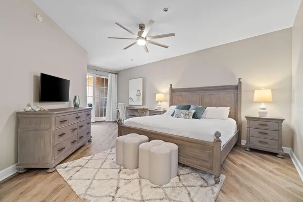 a bedroom with a bed and a flat screen tv