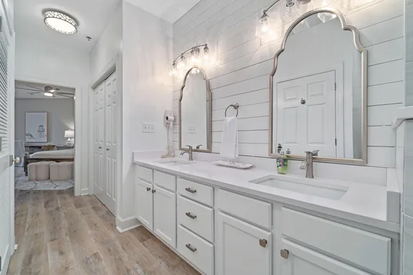 a spacious bathroom with a double vanity sink and a mirror