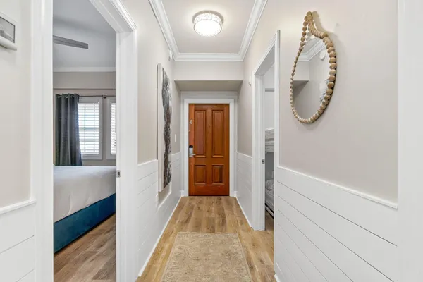 a view of a hallway with wooden floor and entryway